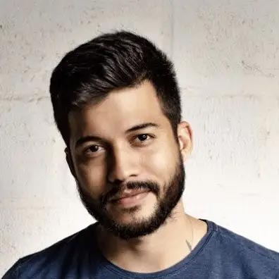 Barber 1 young man with beard smiling and wearing a  brown shirt